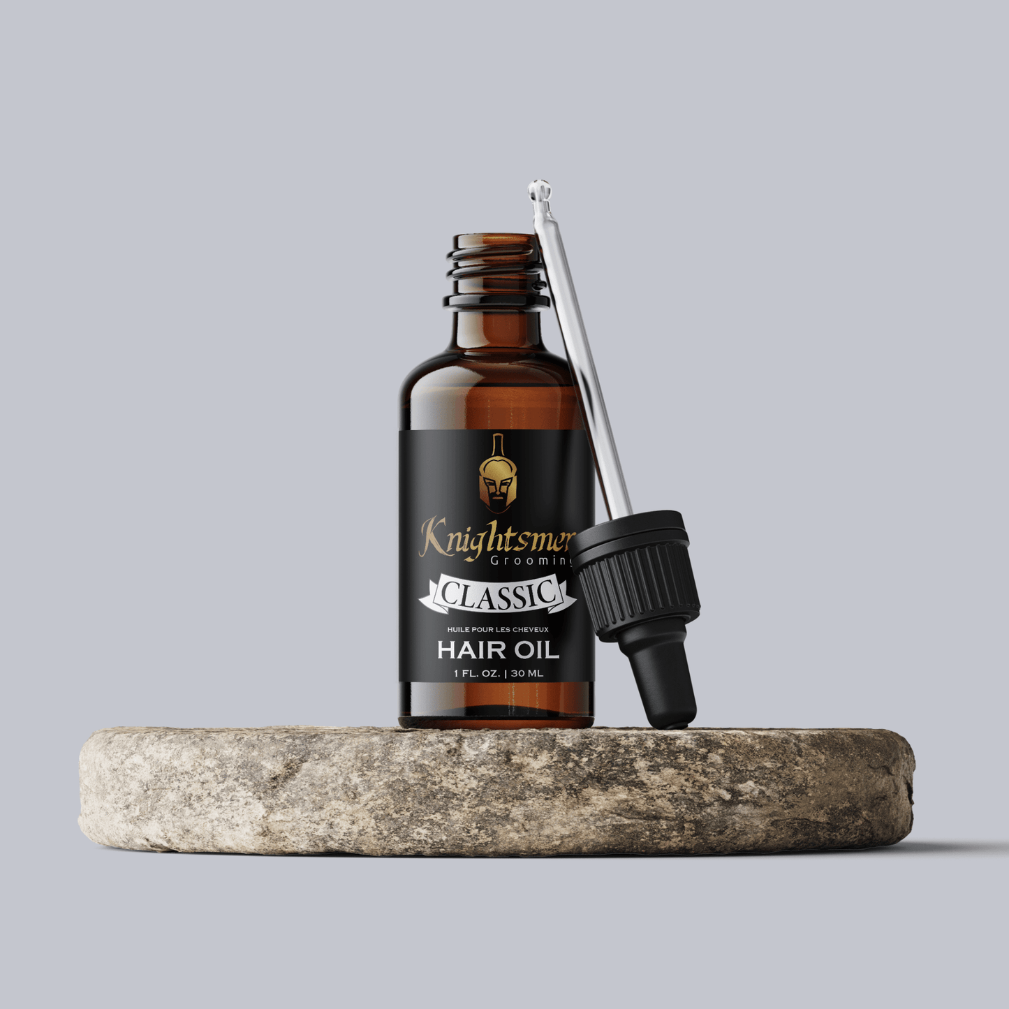 Premium Organic hair oil with glass dropper on stone—hydrating, hair growth formula and strengthening formula.