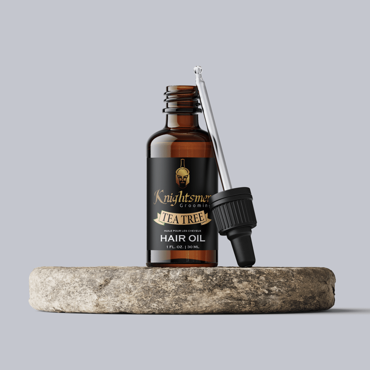 Premium Organic hair oil with glass dropper on stone—hydrating, hair growth formula and strengthening formula for hair growth, tea tree hair oil.