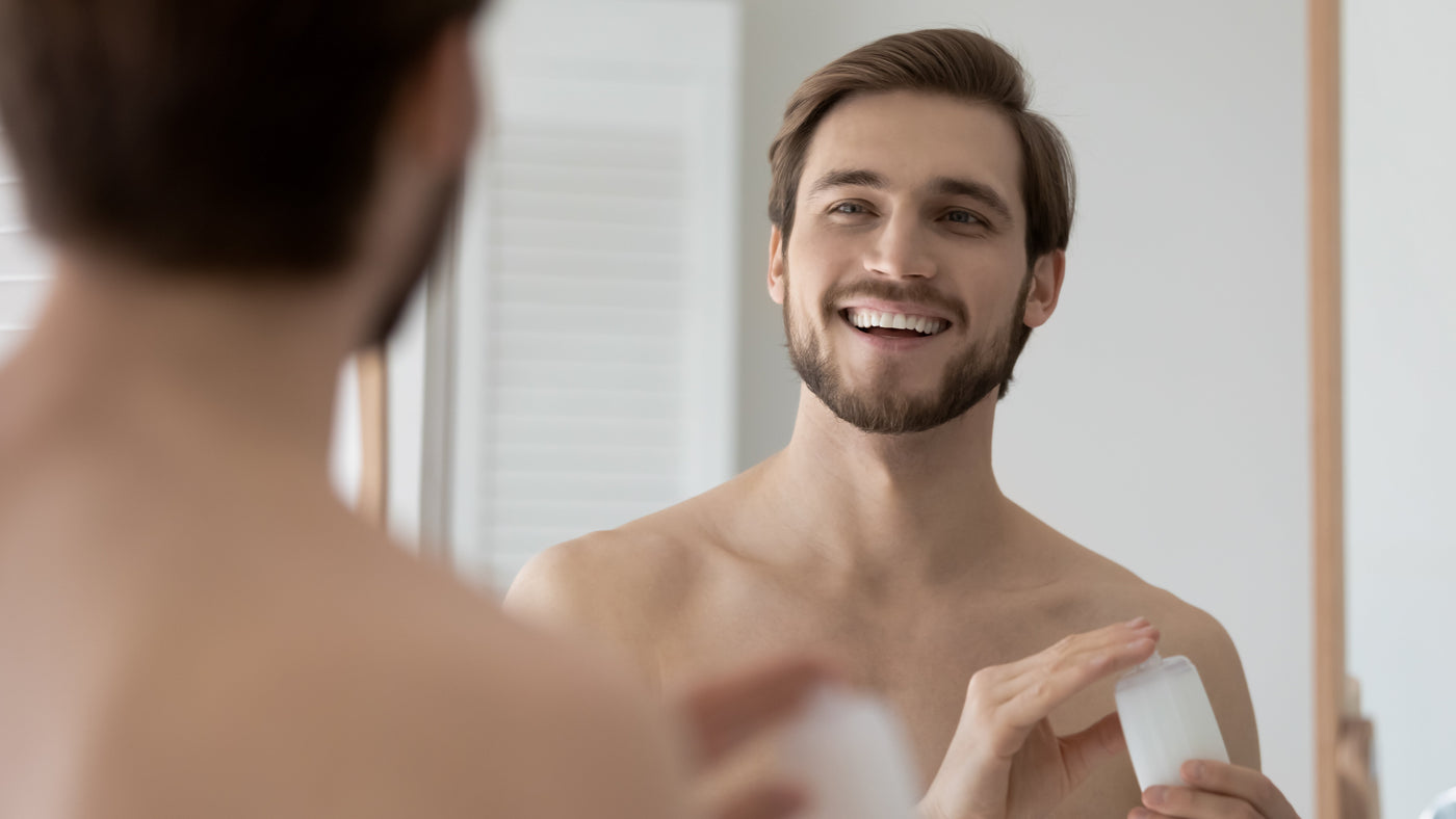 Man washing and caring for his beard in the bathroom