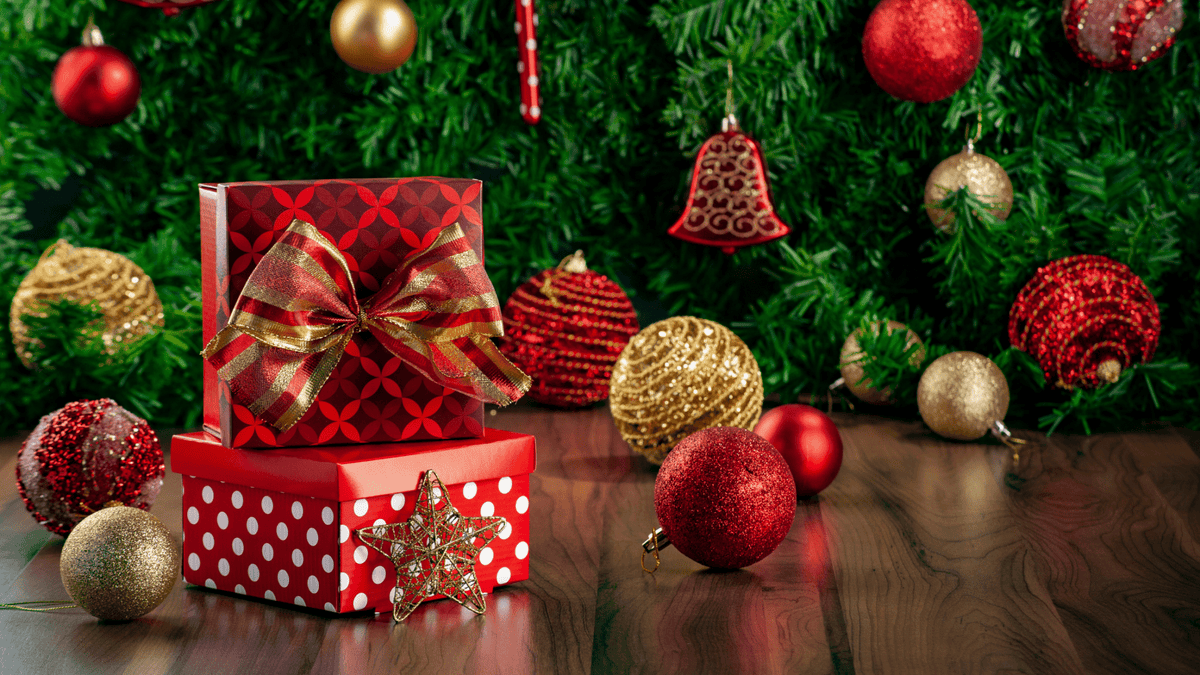 Christmas tree with wrapped grooming gift sets and stockings on a cozy floor.