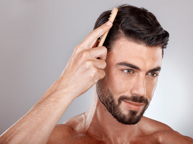 a man combing his hair after applying Knightsmen Grooming hair care products to it