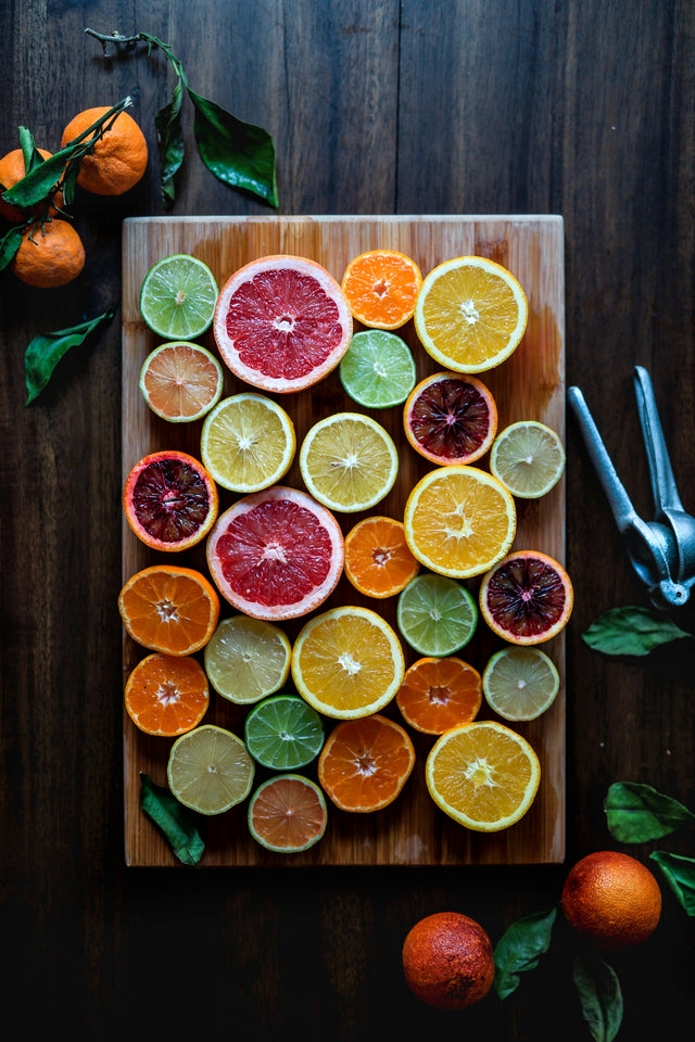Assorted sliced citrus fruits — bright bergamot-adjacent citrus colours echoing the essential oil in Knightsmen Grooming's bergamot hair oil
