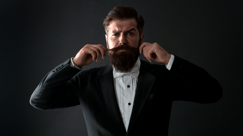 Mustache silhouette with beard oil and balm—Movember prep imagery