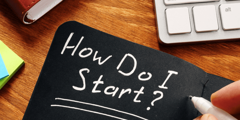 Morning scene with alarm clock, glass of water, and man grooming at a bathroom sink.