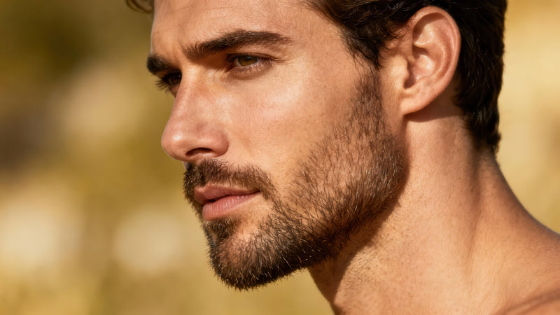 handsome man with short beard using knightsmen grooming beard oil
