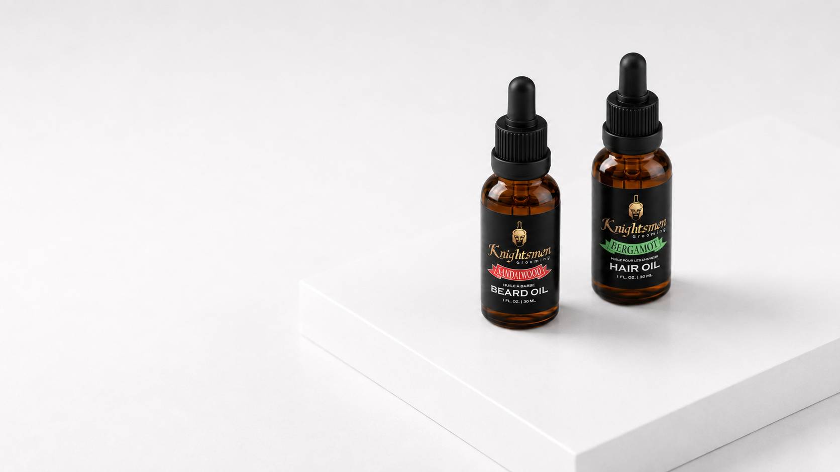 Two amber glass dropper bottles of Knightsmen Grooming beard and hair oils standing on a white platform against a white background.
