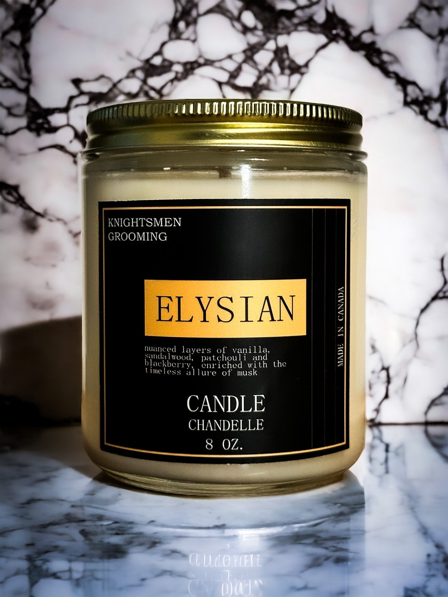 Elysian soy candle creating warm ambiance on a nightstand in a modern bedroom
