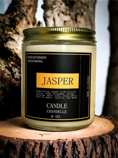 Candle labeled 'Jasper' by Knightsmen Grooming on a wooden surface with a natural background.