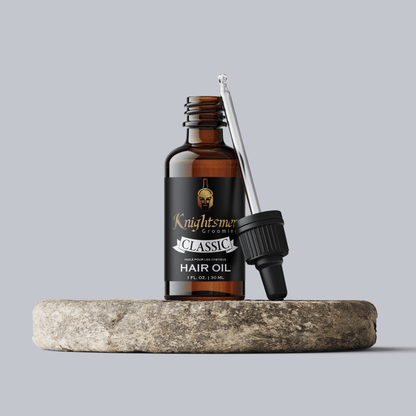 Premium Organic hair oil with glass dropper on stone—hydrating, hair growth formula and strengthening formula.