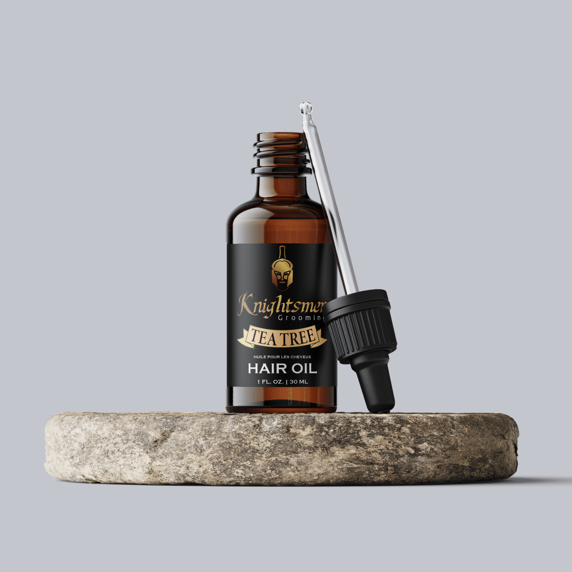 Premium Organic hair oil with glass dropper on stone—hydrating, hair growth formula and strengthening formula for hair growth, tea tree hair oil. 