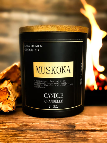 Muskoka soy candle burning with warm amber glow in a cozy living space
