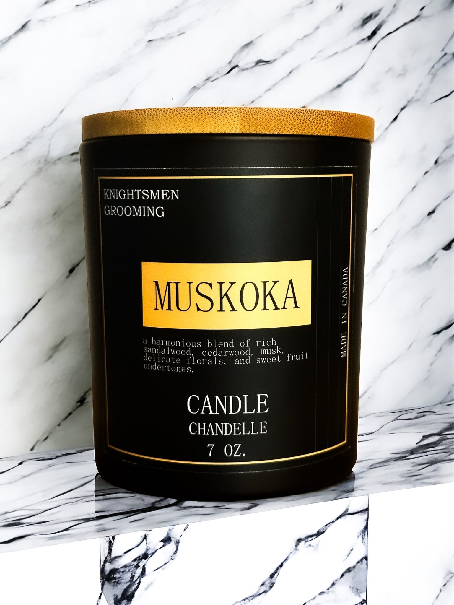 Muskoka candle with gold lid on a marble background