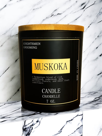 Muskoka candle with gold lid on a marble background