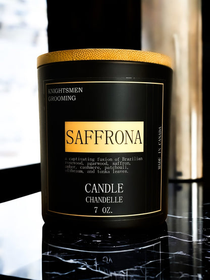 Saffrona candle with gold and black label on a reflective surface