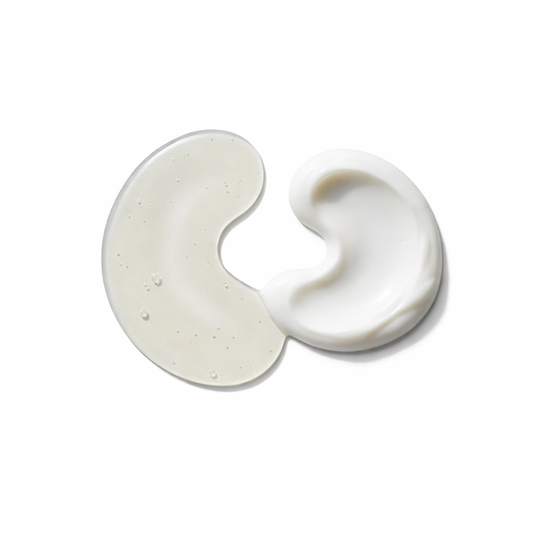 Two swirls of white cream on a light beige background